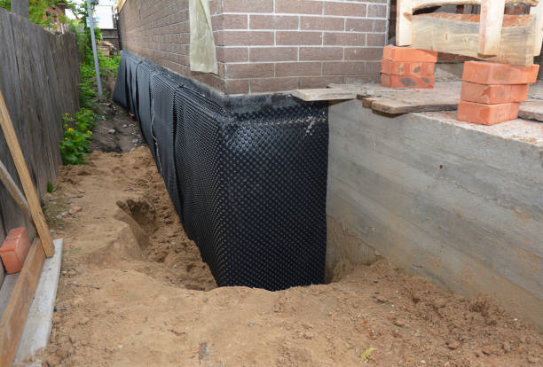 SJ Waterproofing Pros technician performing targeted Wet Basement Repair assessment in Midland, OH